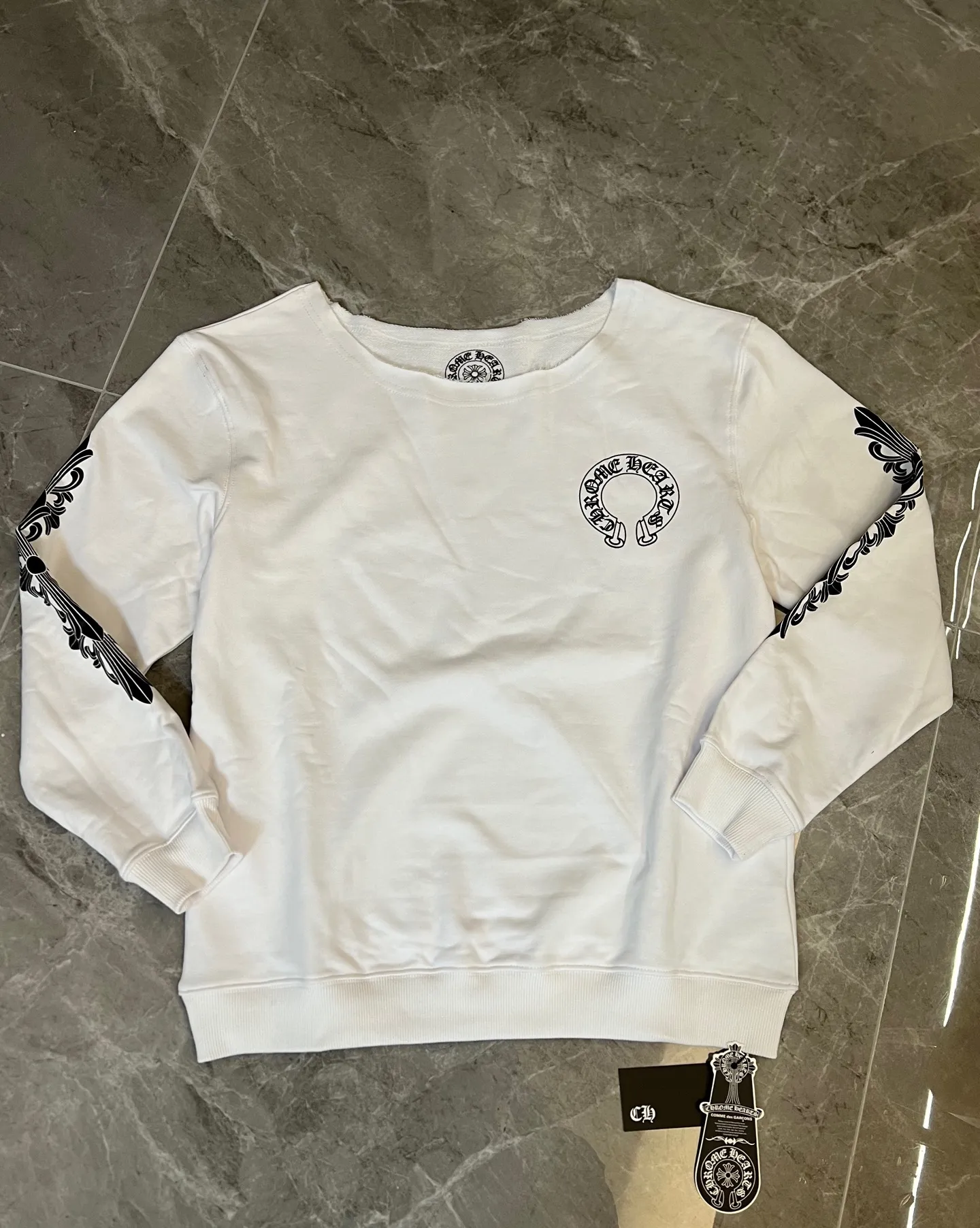 P186 [Next day] Chrome Hearts/Chrome Hearts 25ss CH Arm Cross Horseshoe Sanskrit Sloping Shoulder Sweatshirt (White - Women's Loose) Custom-woven fabric with a delicate and soft texture, gentle and non-prickly. The brand's Sanskrit inscriptions highlight the brand's unique American dark heavy industry trend style from all angles. It is fashionable and avant-garde. The unique OVEISIZE cut is more in line with the aesthetic style of the Z generation young people. It is an indispensable goddess wardrobe item!  Size: s m l. Available in seconds. Detailed sizes can be found in Figure 9.